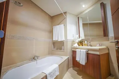 a bathroom with a tub and a sink at Modern 2BR with Balcony Sea Views and Pool, Gym Near Attractions in Dubai