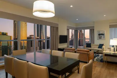 a dining room and living room with a view of the city at Four Points by Sheraton Sheikh Zayed Road in Dubai