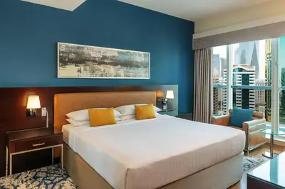 a bedroom with a large bed and a large window at Four Points by Sheraton Sheikh Zayed Road in Dubai