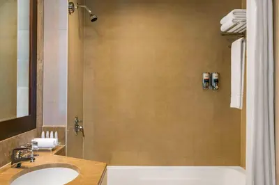a bathroom with a tub and a sink and a shower at Four Points by Sheraton Sheikh Zayed Road in Dubai
