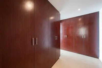 a hallway with wooden cabinets in a room at Nasma Luxury Stays- Majestic Marina Views, Lavish 4BR Getaway in JBR in Dubai