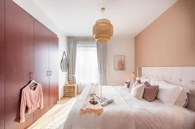a bedroom with a large bed and a large window at Nasma Luxury Stays- Majestic Marina Views, Lavish 4BR Getaway in JBR in Dubai