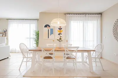 a dining room with a white table and chairs at Nasma Luxury Stays- Majestic Marina Views, Lavish 4BR Getaway in JBR in Dubai