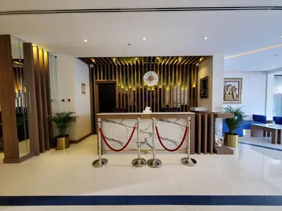 a lobby with a table with a red rope at Skylark Hotel Apartments AL Barsha in Dubai