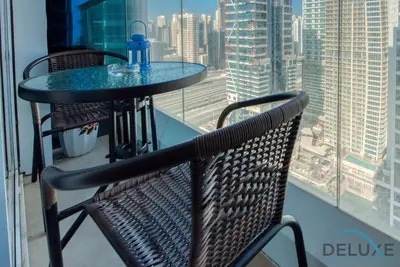 a table and chairs with a view of a city at Next to Lake 2BR Apartment Accessible to Metro, Dubai Gate 2, Jumeirah Lake Towers by Deluxe Holiday Homes in Dubai