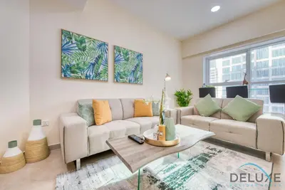 a living room with two couches and a table at Next to Lake 2BR Apartment Accessible to Metro, Dubai Gate 2, Jumeirah Lake Towers by Deluxe Holiday Homes in Dubai