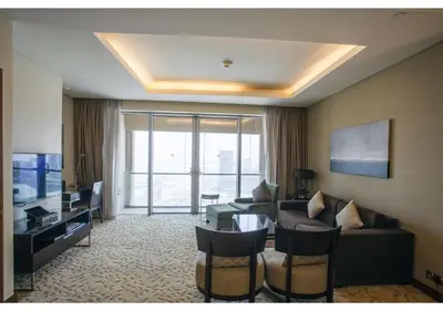 a living room with a couch and a television at Dubai Mall Residences -Luxury 1 bedroom in Dubai
