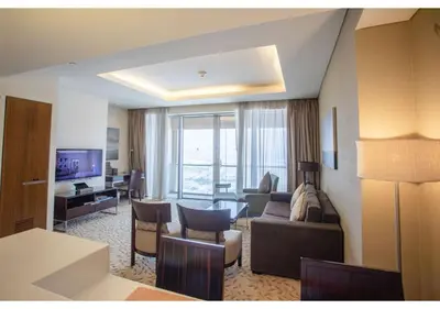 a living room with a couch and a table at Dubai Mall Residences -Luxury 1 bedroom in Dubai