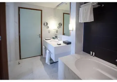 a bathroom with a tub and a sink and a bath tub at Dubai Mall Residences -Luxury 1 bedroom in Dubai