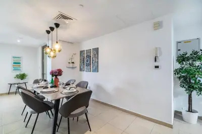 a dining room with a table and chairs at The Smart Concierge - Bahar 1 in Dubai