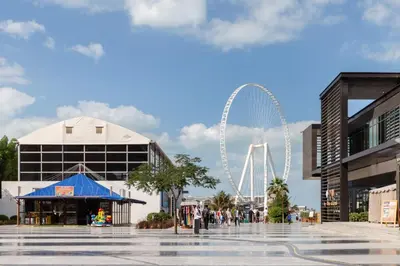 a view of a ferris wheel in a city at The Smart Concierge - Bahar 1 in Dubai