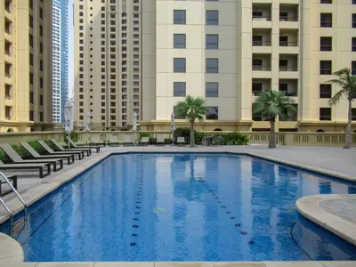 a large swimming pool with buildings in the background at The Smart Concierge - Bahar 1 in Dubai