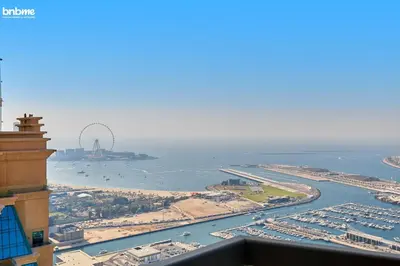 an aerial view of a harbor with the ferris wheel at bnbme - Dubai Marina 54th Floor Apt Sea View Two Balconies Pool Gym & Parking in Dubai