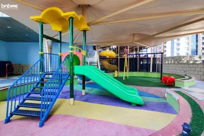 a playground with a slide in a tent at bnbme - Dubai Marina 54th Floor Apt Sea View Two Balconies Pool Gym & Parking in Dubai