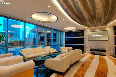 a salon with white chairs and a waiting room at bnbme - Dubai Marina 54th Floor Apt Sea View Two Balconies Pool Gym & Parking in Dubai