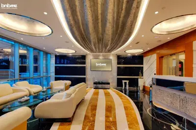 a salon with a waiting room with white chairs and a ceiling at bnbme - Dubai Marina 54th Floor Apt Sea View Two Balconies Pool Gym & Parking in Dubai
