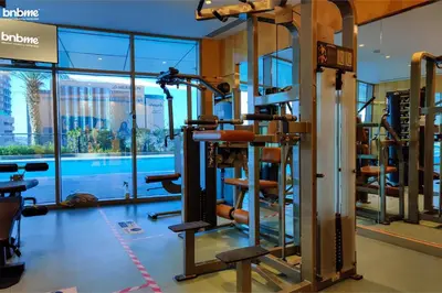 a gym with tread machines in a building at bnbme - Dubai Marina 54th Floor Apt Sea View Two Balconies Pool Gym & Parking in Dubai