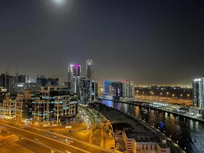 a view of a city at night with traffic at Luton Vacation Homes - Damac Maison Prive Studio, Canal View, Dubai - 16AB03 in Dubai