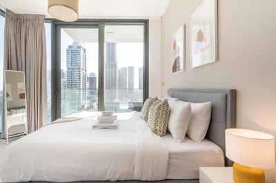 a bedroom with a bed with a large window at GuestReady Holiday Homes - A Sigh of Bliss in Dubai