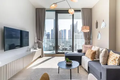 a living room with a couch and a tv at GuestReady Holiday Homes - A Sigh of Bliss in Dubai