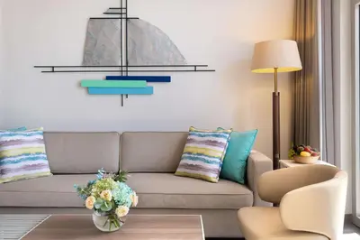 a living room with a couch and a table at JA Palm Tree Court, Dubai in Dubai