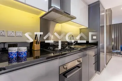 a kitchen with a stainless steel stove top oven at Staycae Holiday Homes - Prive in Dubai