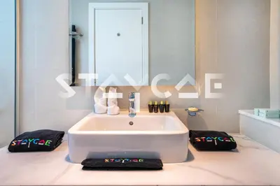 a bathroom with a large white bath tub in a room at Staycae Holiday Homes - Prive in Dubai