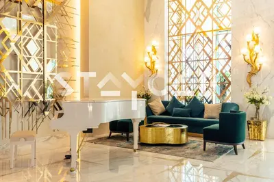 a living room with a couch and a white piano at Staycae Holiday Homes - Prive in Dubai