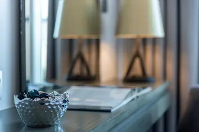 a desk with a mirror and a bowl on it at The Smart Concierge - Damac Maison Prive in Dubai