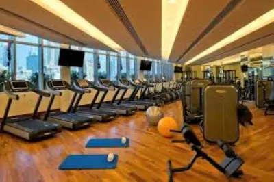 a gym with a row of treadmills and exercise equipment at Fashion Avenue Dubai Mall Residences - Studio with balcony in Dubai
