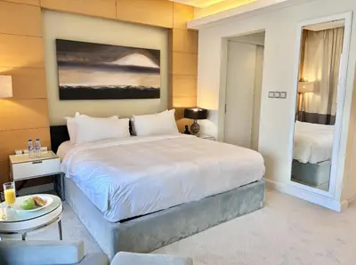 a bedroom with a large white bed in a room at Fashion Avenue Dubai Mall Residences - Studio with balcony in Dubai