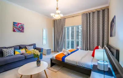 a living room with a bed and a couch at RH- Perfect Downtown Getaway for Couple, Near Dubai Mall in Dubai