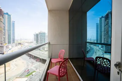 a balcony with pink chairs and a view of a city at RH- Perfect Downtown Getaway for Couple, Near Dubai Mall in Dubai