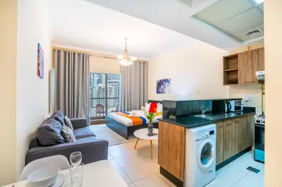 a kitchen and living room with a couch and a table at RH- Perfect Downtown Getaway for Couple, Near Dubai Mall in Dubai