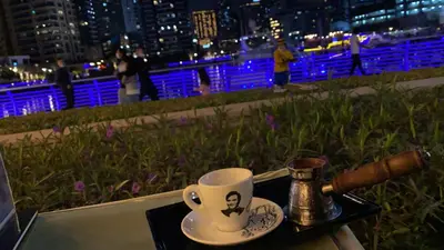 a coffee cup sitting on a table with a gun at Luxury 1br in Dubai Marina, ask for July Full month offer in Dubai