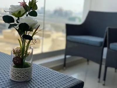 a vase with flowers in it sitting on a table at Luxury 1br in Dubai Marina, ask for July Full month offer in Dubai