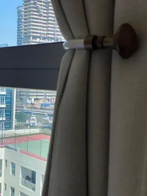 a curtain in a window with a tennis court at Luxury 1br in Dubai Marina, ask for July Full month offer in Dubai