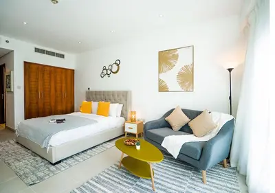a bedroom with a bed and a couch at Nasma Luxury Stays - Boulevard Central Tower in Dubai