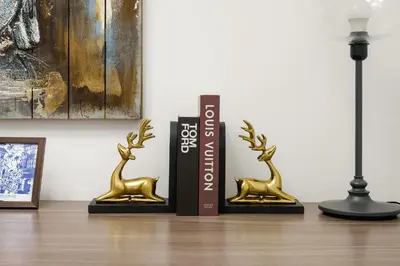 two trophies sitting on a table next to a lamp at FIRST CLASS 3BR Burj Khalifa & Fountain View in Dubai