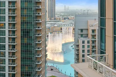 a view of the fountain in the middle of buildings at FIRST CLASS 3BR Burj Khalifa & Fountain View in Dubai