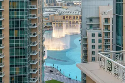 a view of the waterfalls from the balcony of a building at FIRST CLASS 3BR Burj Khalifa & Fountain View in Dubai