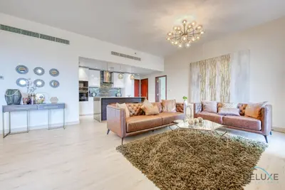 a living room with two couches and a table at Glamorous 1BR Apartment in Rimal 3 Jumeirah Beach Residence by Deluxe Holiday Homes in Dubai