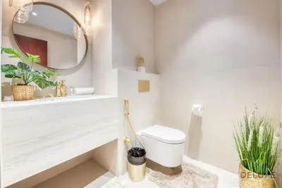 a white bathroom with a toilet and a mirror at Glamorous 1BR Apartment in Rimal 3 Jumeirah Beach Residence by Deluxe Holiday Homes in Dubai