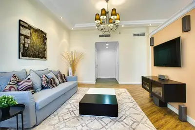 a living room with a couch and a tv at Stunning 2BD sea view apartment in Jbr in Dubai