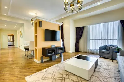 a living room with a couch and a tv at Stunning 2BD sea view apartment in Jbr in Dubai