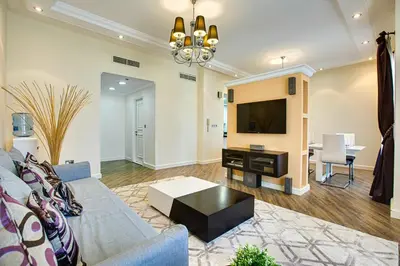 a living room with a couch and a tv at Stunning 2BD sea view apartment in Jbr in Dubai