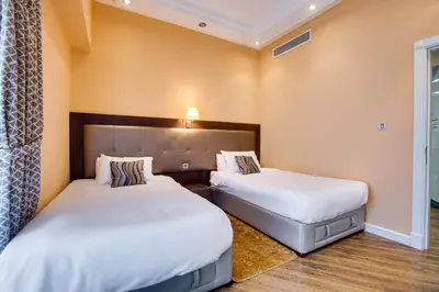 two beds in a hotel room with white sheets at Stunning 2BD sea view apartment in Jbr in Dubai