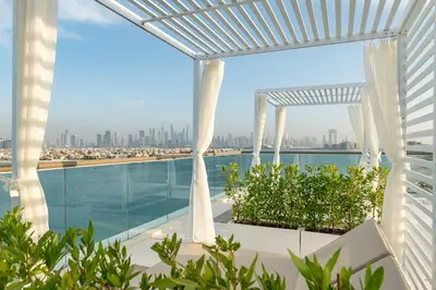 a view of the city from the balcony of a building at Th8 Palm Dubai Beach Resort, Vignette Collection by IHG in Dubai