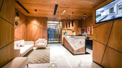 a lobby with wood paneled walls and a bar at City Stay Residences - Serviced Apartments Al Barsha in Dubai