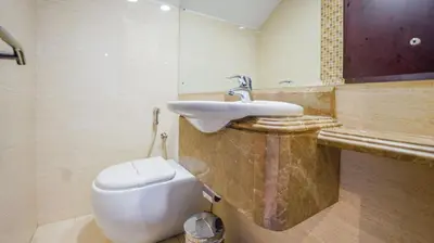 a bathroom with a white toilet and a sink at City Stay Residences - Serviced Apartments Al Barsha in Dubai